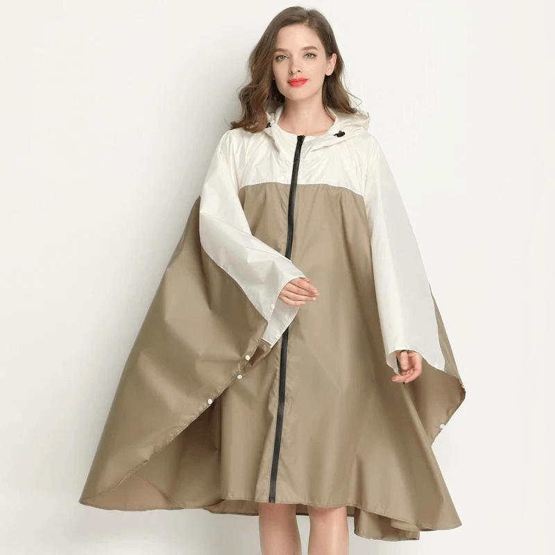 Women's raincoat-poncho with zipper and hood, waterproof and windproof polyester, in a stylish beige and white design.